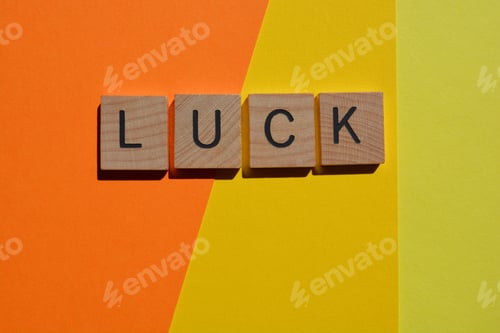 Preview: Luck, word in 3D wooden alphabet letters on yellow background with copy space.