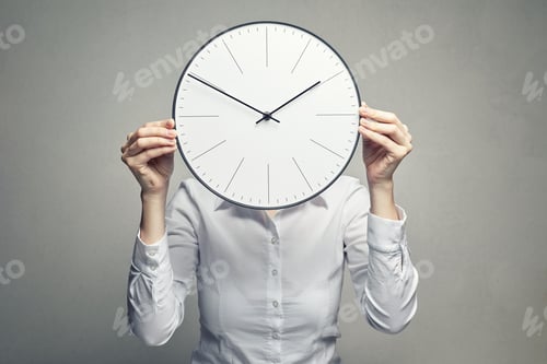 Preview: business woman covering her face with clock