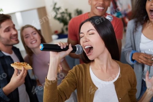 Preview: Karaoke party. Beautiful young asian girl holding microphone and singing while playing karaoke with