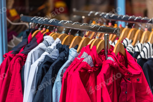 Preview: Bright raincoats hanging at a fashion store