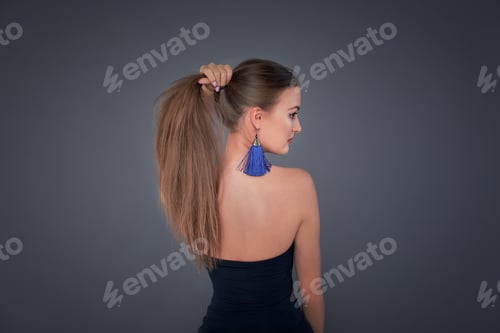 Preview: Minimalist photo, Fashionable girl in stylish holding his long hair in the tail, view from the back