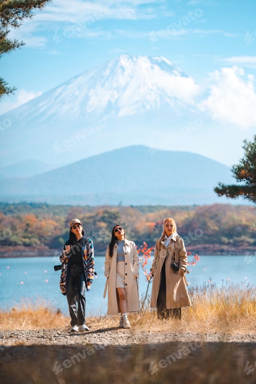 Preview: Happy tourist traveler woman or man enjoying on lake kawaguchiko with mount fuji in japan