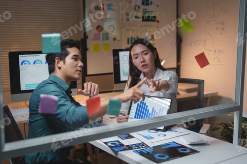 Preview: Business colleagues collaborating on data analysis during night office work