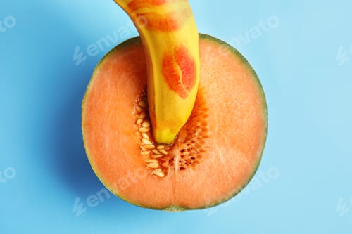 Preview: Flat lay composition with fresh banana and melon on blue background. Sex concept