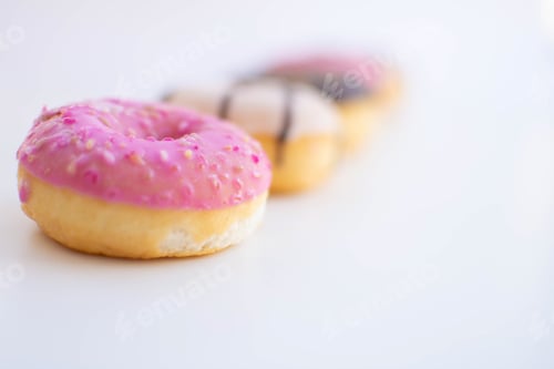 Preview: Pink Iced Doughnuts in a Row on White