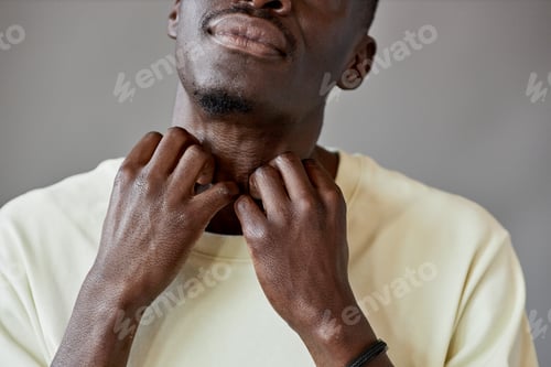 Preview: Closeup of Black Man Scratching Neck