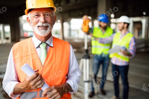 Preview: Team of business people in group, architect and engeneer on building site check documents