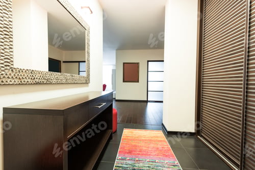 Preview: close up view of mirror hanging on wall in corridor