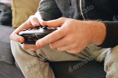 Preview: Close up of hands holding a controller, playing video games