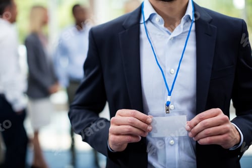 Preview: Mid section of employee showing Id card