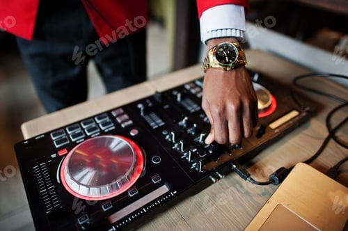 Preview: Hands of fashion african american man model DJ at red suit with dj controller.