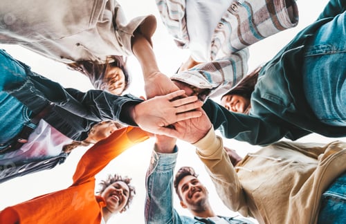 Preview: Community of young people stacking hands together