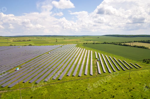 Preview: Aerial view of solar power plant on green field.