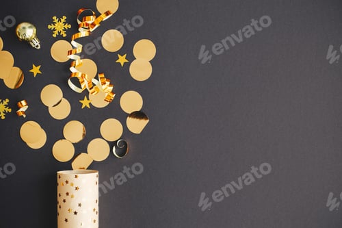 Preview: Modern golden confetti popping on black paper, new year firework creative flat lay. Happy New Year