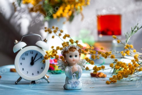 Preview: Easter greeting card. Festive composition with mimosa flowers, angel and clock eve of the holiday