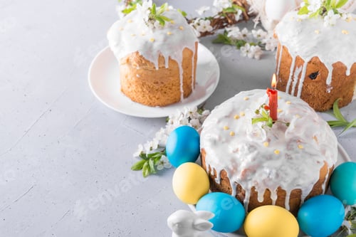 Preview: Easter cake and yellow painted eggs on grey table decorated spring flowers.