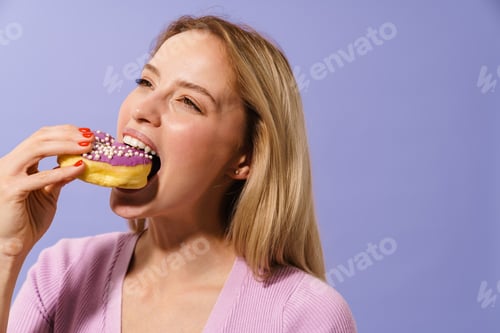 Preview: Happy charming blonde girl eating doughnut on camera