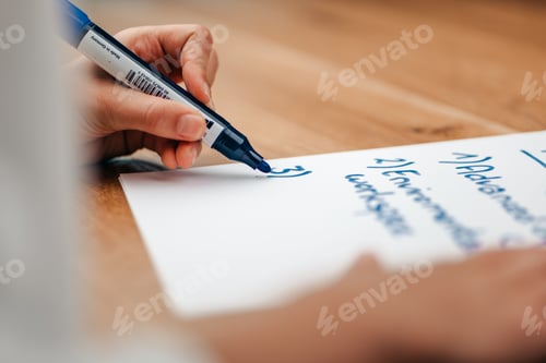 Preview: businesswoman writing some bullet points on a paper