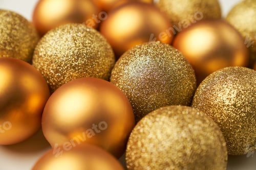 Preview: selective focus on golden Christmas balls with different textures and glitters
