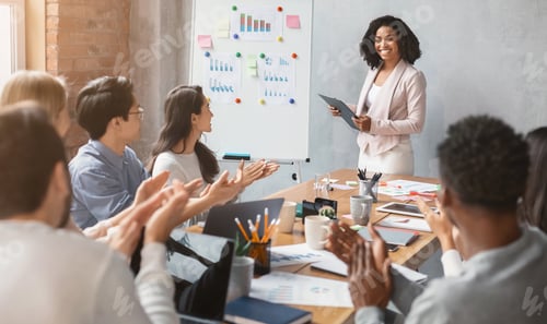 Preview: International business team applausing to black lady speaker