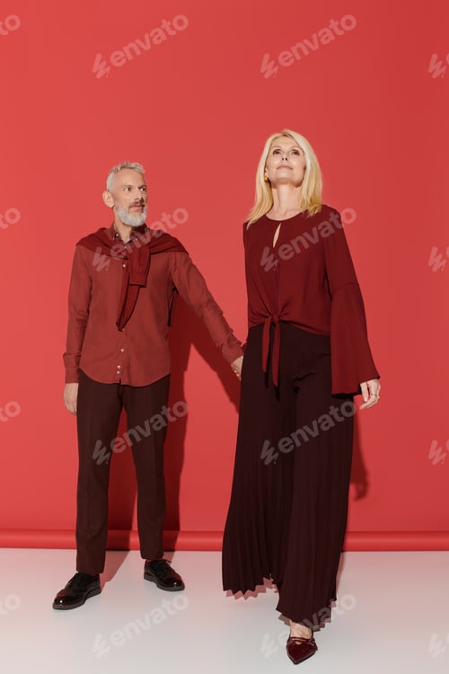 Preview: Stylish senior couple expresses love through fashion in a vibrant setting