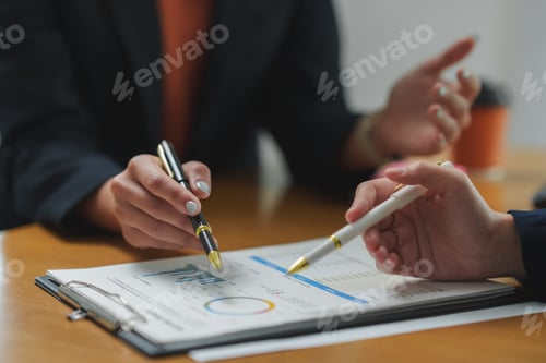 Preview: Businesswomen analyzing financial charts and discussing investment strategies