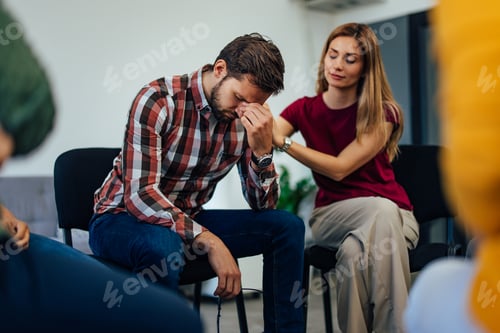 Preview: Support Group Session with Woman Comforting a Troubled Man in Discussion