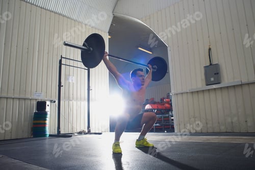 Preview: Man lifting barbell in gym