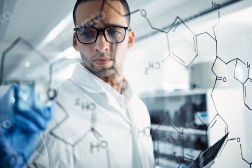 Preview: Shot of a young scientist solving equations on a glass screen in a laboratory