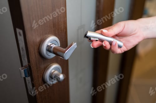 Preview: Broken Metal Door Handle in Female Hand Close Up Concept of Low Quality Hardware or Home Repair