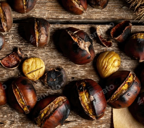 Preview: Roasted chestnuts scattered on rustic wooden table