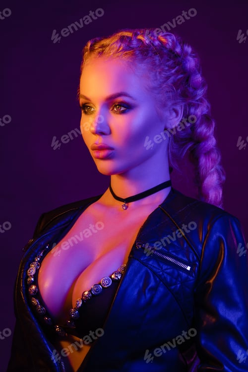 Preview: Portrait of seductive young European woman surrounded by evening neon lights medium close-up