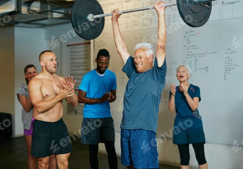 Preview: Shot of a senior man lifting weights while a group of people in the background watch on