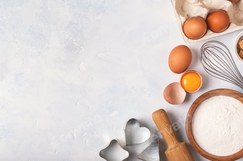 Preview: Ingredients for baking - flour, wooden spoon, eggs.