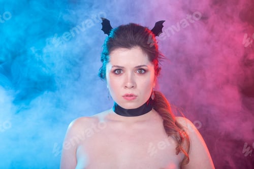 Preview: Halloween, holidays and carnival concept - portrait of woman in gothic style is looking very serious