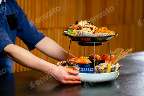 Preview: close up in a Japanese restaurant chef in blue prepares an expensive plate of seafood