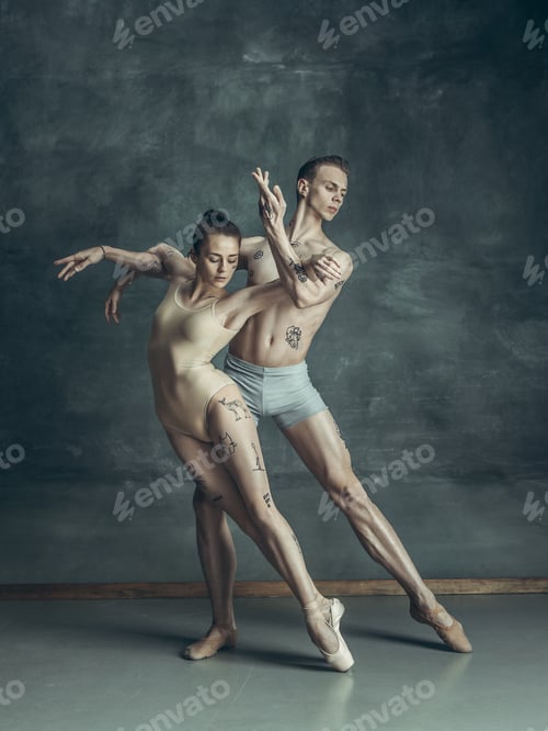 Preview: The young modern ballet dancers posing on gray studio background