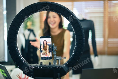 Preview: Closeup mobile phone recording video or live streaming for sell fashion dress