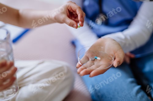 Preview: Close up of nurse giving pills to patient.