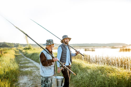 Preview: Grandfather with adult son walking near the lake