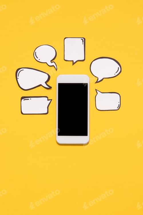 Preview: Close-up view of smartphone with black screen and blank speech bubbles isolated on yellow