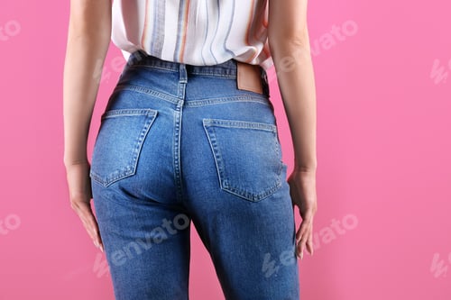 Preview: Woman in stylish blue jeans on color background