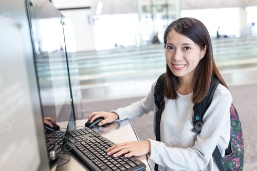 Preview: Woman searching on computer in the airport