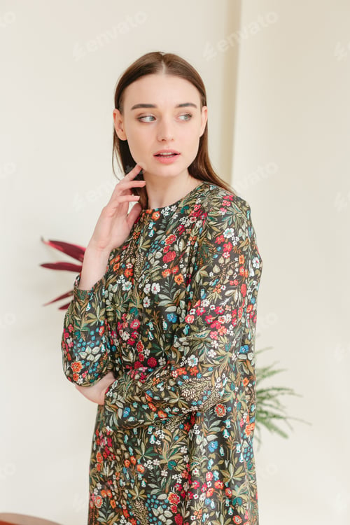 Preview: Beautiful young woman in a fancy spring dress posing in a photostudio.