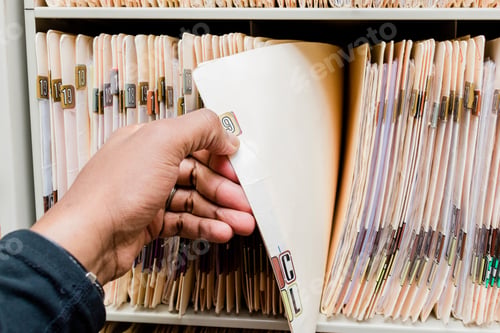 Preview: Medical records, charts, African American man sorting through patient charts