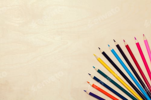 Preview: Colorful pencils arrangement on grey background close up