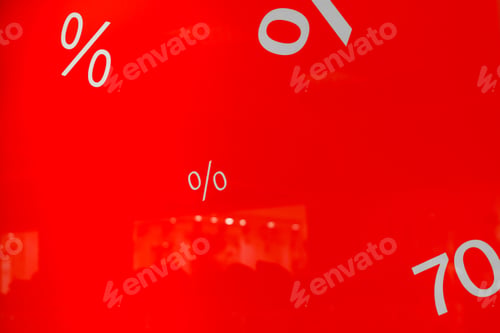 Preview: Discount signs on red background shop window in shopping mall. Holiday sale concept