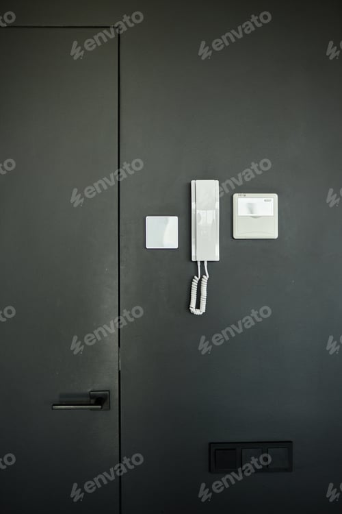 Preview: Intercom Handset with Electronic Video Panel Mounted on Black Wall in Apartment