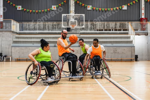 Preview: Diverse athletes playing wheelchair basketball on court