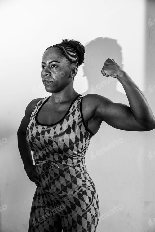 Preview: Young African American woman wearing a sports outfit and striking a confident pose